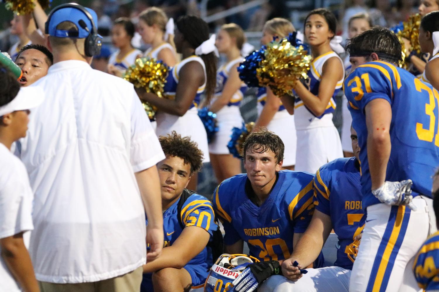 Robinson varsity football players gather on the sidelines during their win against Chantilly on August 31. Photo by Thomas Redifer.