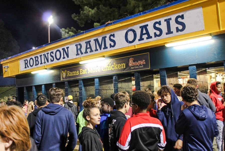 Students stand outside of the oasis at a football game. Robinson oasis has been a service for the high school for over thirty years. 
