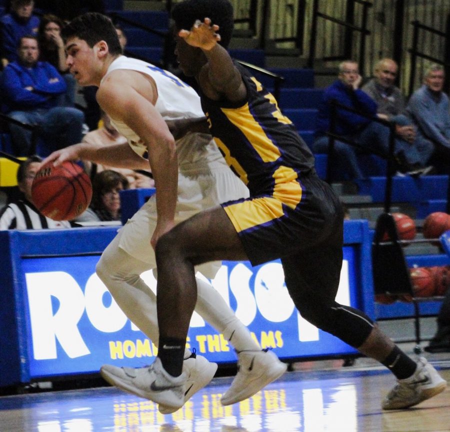Ethan Rothstein dribbles as a Lake Braddock player attempts to guard him. 