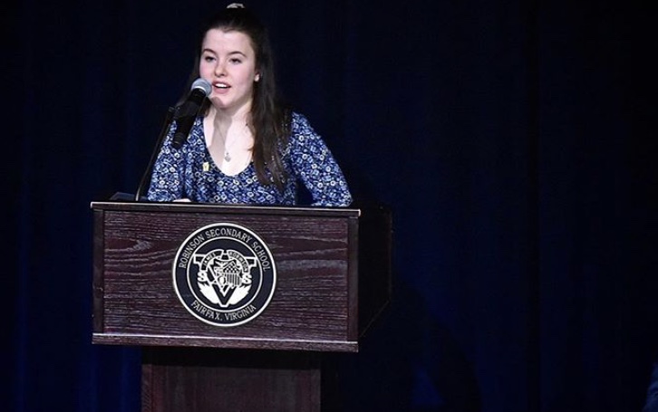 Senior Carrie Walker, the National Honors Society president, speaks at the induction ceremony in 2019. 
