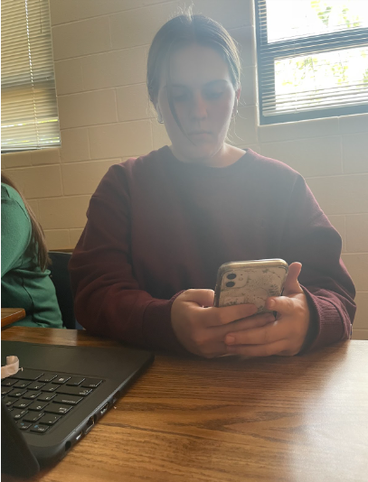 Student using their phone in class. The new phone policy implemented at the beginning of the school year has had a huge impact on students and teachers.