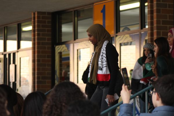 Senior Muna Ali speaks to students attending the walkout. I was very happy with the turnout, said Ali.