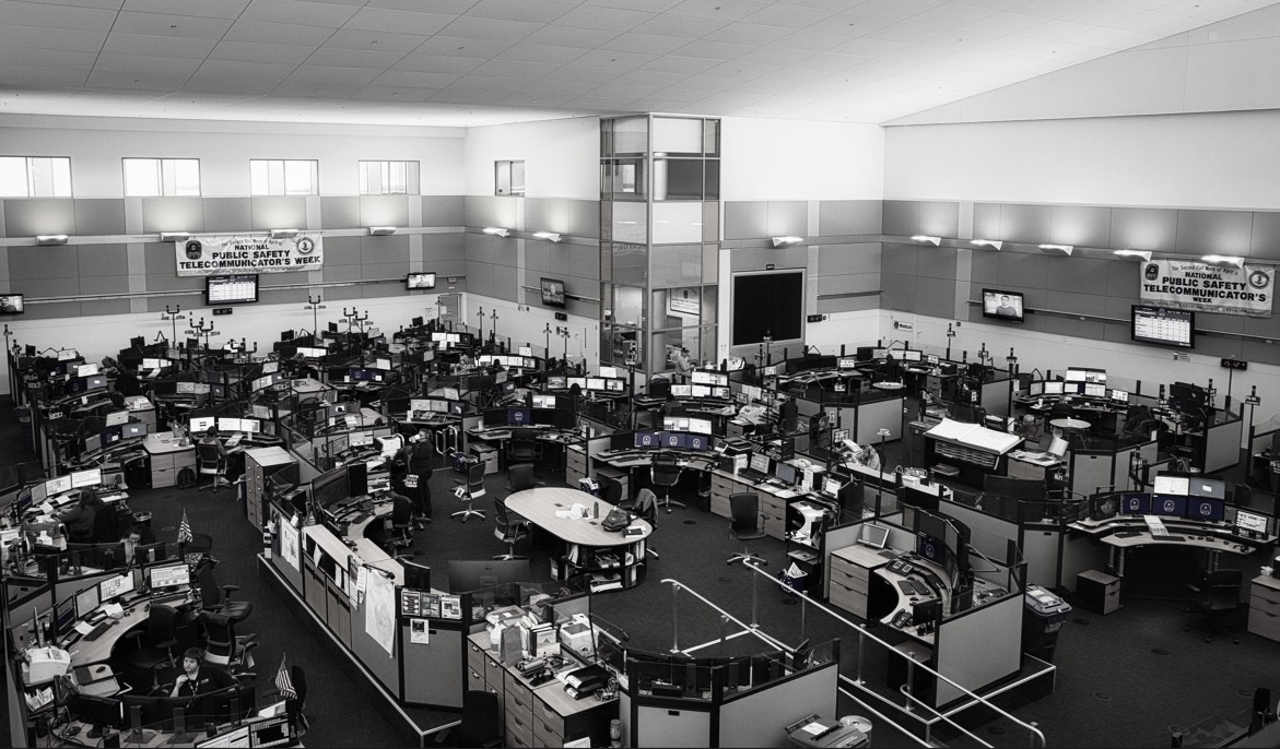 A photograph of the 911 operations floor at the Fairfax County DPSC. The Arlington County ECC is currently the only center in Virginia using AI within the 911 center, but other areas within the state have started pursuing it.   